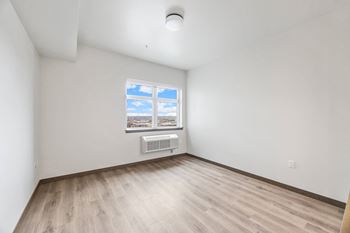 an empty room with white walls and a window